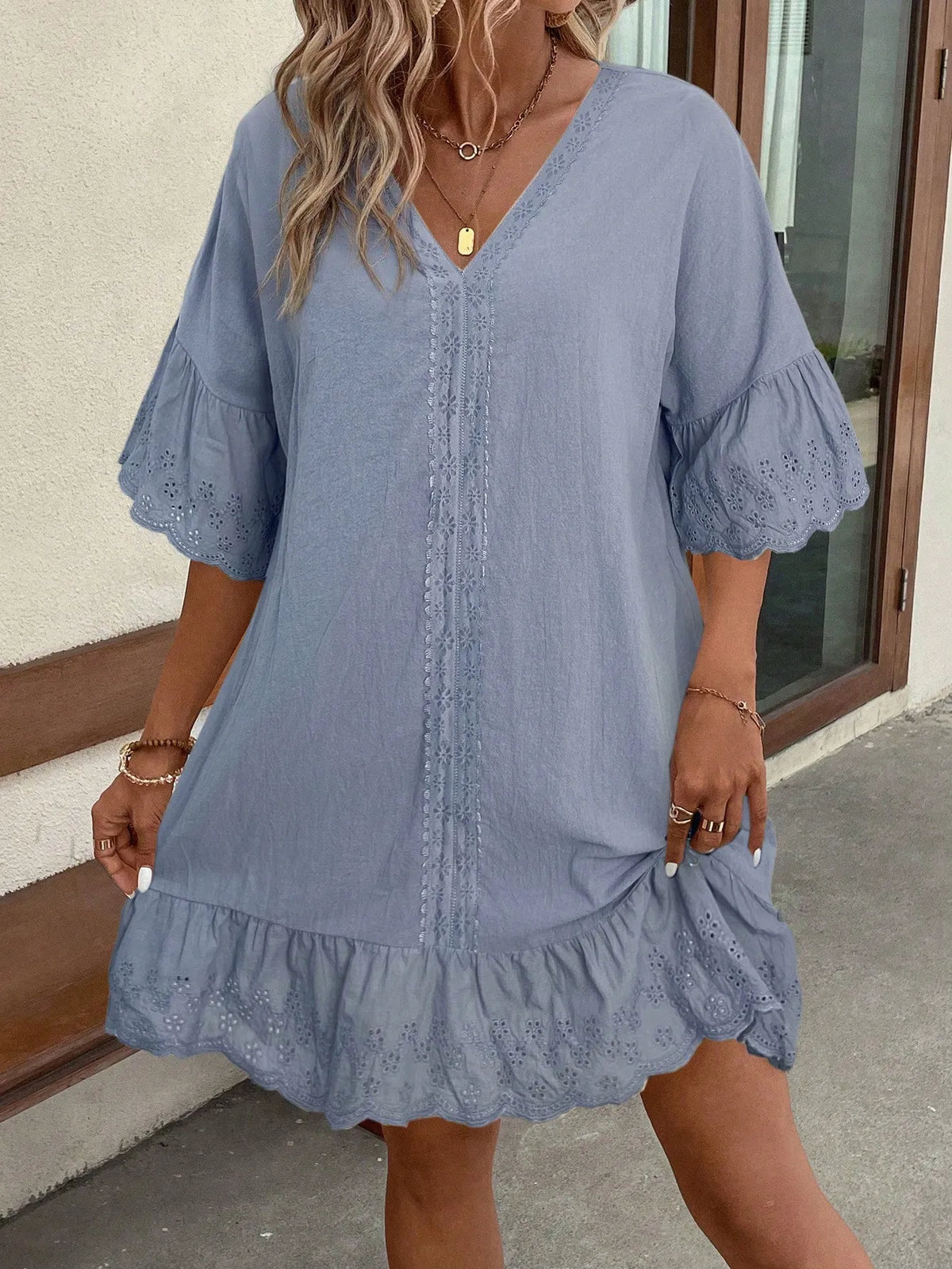 Front view of the light blue V-neck dress with flutter sleeves and a ruffled hem