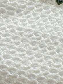 Close-up of the white textured swimsuit fabric