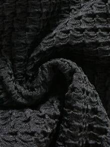 Close-up of the black textured swimsuit fabric