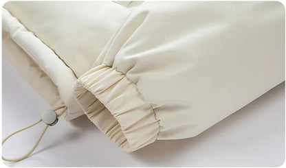 Close-up of the white parka's elastic cuff and hem drawstring
