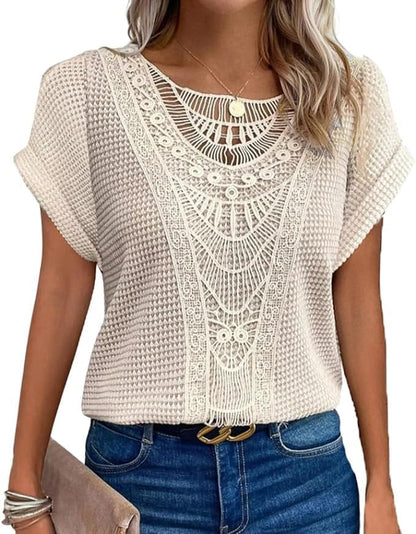 Woman wearing a cream waffle-knit tunic top with a crochet lace front and jeans