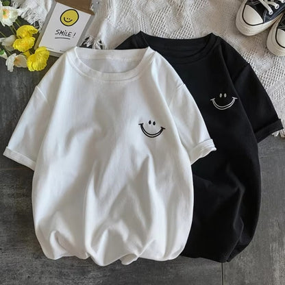 White and black casual T-shirts with a small embroidered smile face on the chest