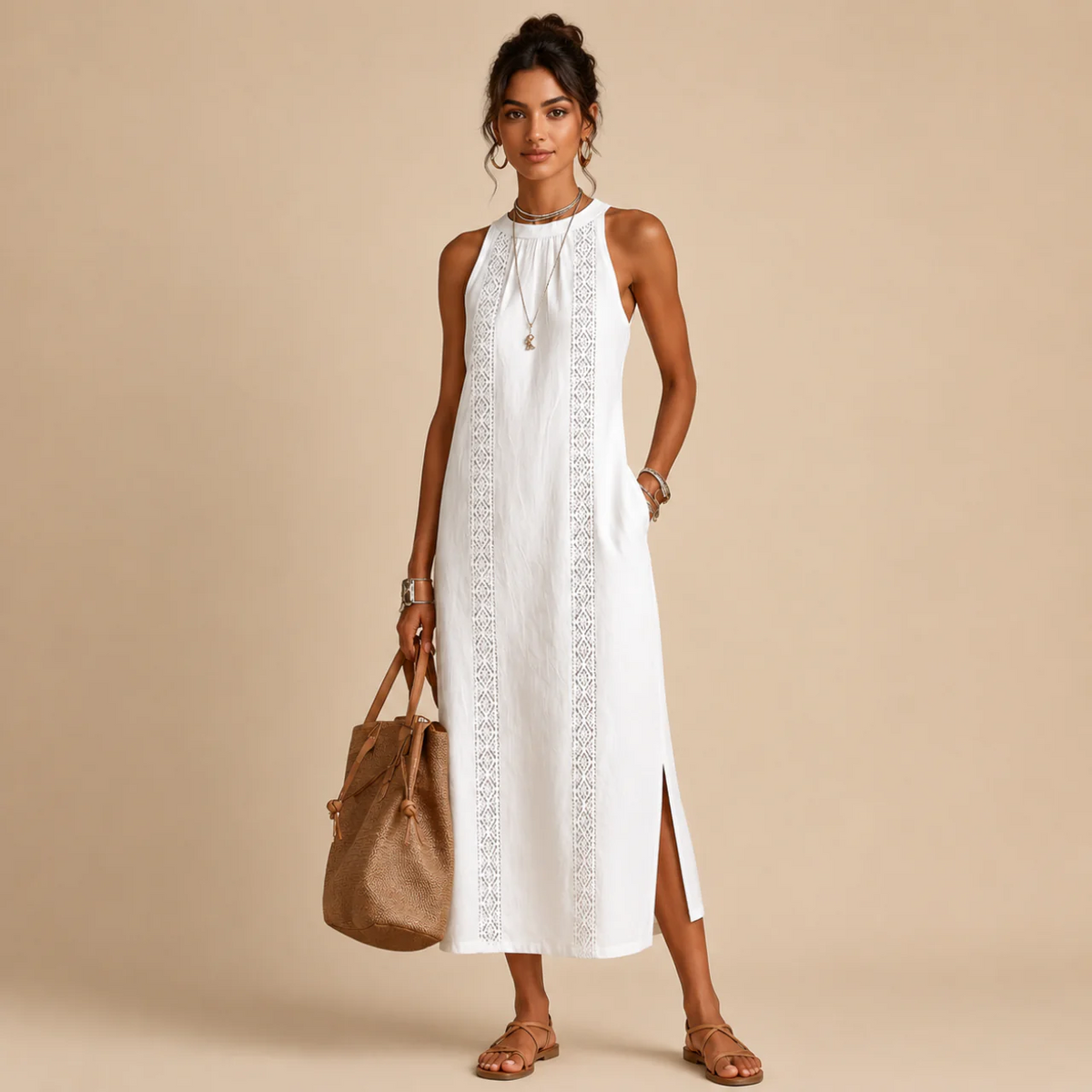Woman wearing a white sleeveless halter-neck dress with a lace-trim center panel and a side slit, holding a tan tote bag