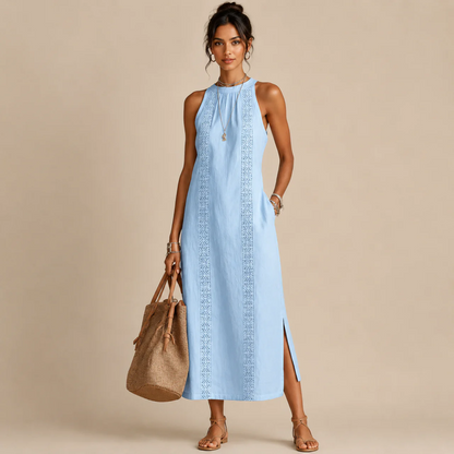 Woman wearing a light blue sleeveless halter-neck dress with a lace-trim center panel and a side slit, holding a tan tote bag