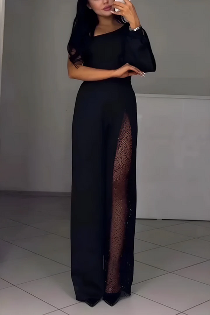 Black one-shoulder jumpsuit with a sheer lace leg slit, front view standing
