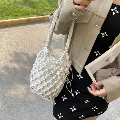 Woman carrying the white knotted-rope bag on her arm