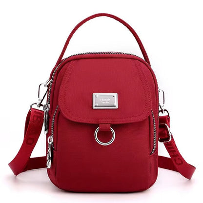Small red shoulder bag with front flap pocket, front view