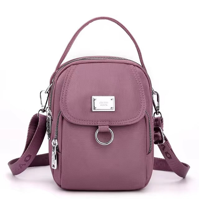 Small mauve pink shoulder bag with front flap pocket, front view