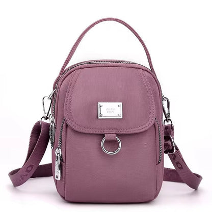 Small mauve pink shoulder bag with front flap pocket, front view