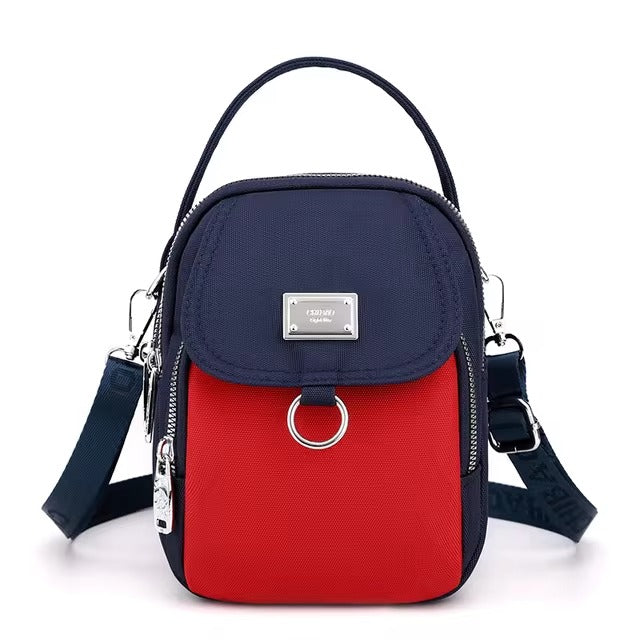 Small navy and red color-block shoulder bag, front view