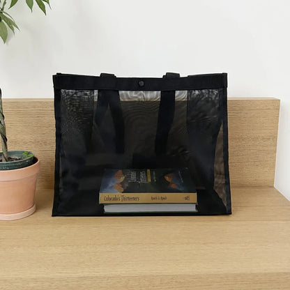 Black sheer mesh bag with books visible inside, front view