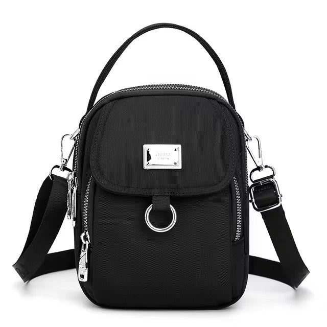 Small black shoulder bag with front flap pocket, front view