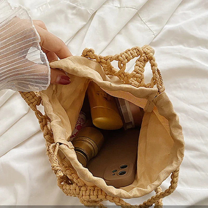 Inside of the knotted-rope bag, showing the fabric drawstring lining holding a phone and small items