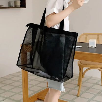 Woman carrying the black sheer mesh bag on her shoulder