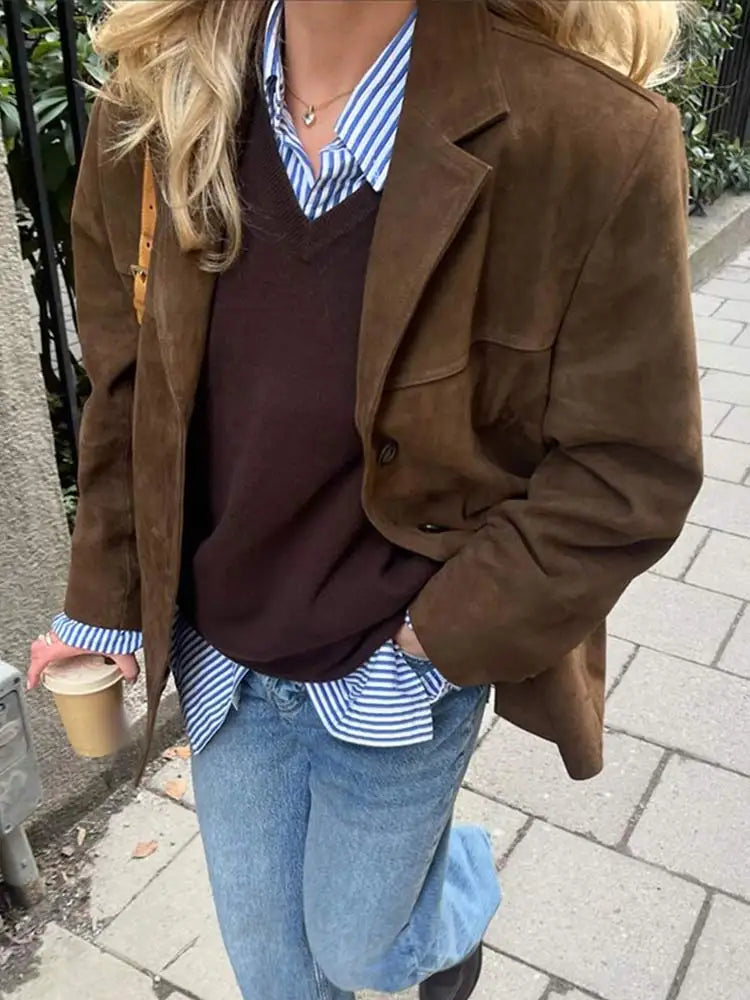 Brown suede-look jacket styled with a sweater, striped shirt and jeans