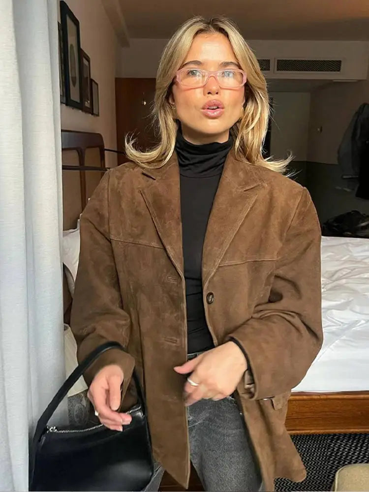 Woman wearing a brown suede-look oversized blazer jacket over a black turtleneck