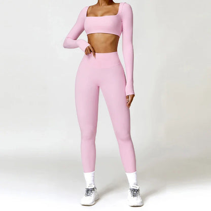 Woman wearing a pink long-sleeve crop top and leggings training set