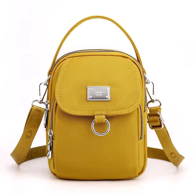 Small mustard yellow shoulder bag with front flap pocket, front view