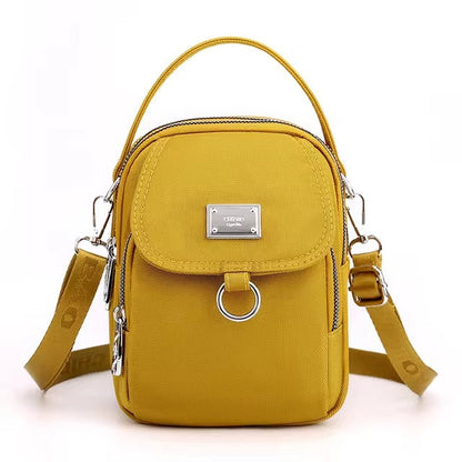 Small mustard yellow shoulder bag with front flap pocket, front view