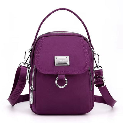 Small purple shoulder bag with front flap pocket, front view