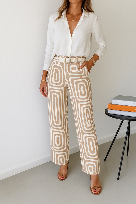Woman wearing a white button-up shirt with beige and white geometric print wide-leg pants