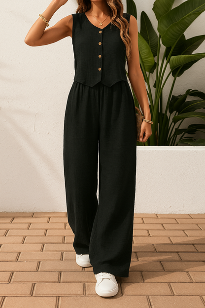 Woman wearing a black sleeveless button-front top and matching wide-leg pants