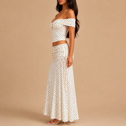 Side view of the cream polka dot crop top and long flowing skirt