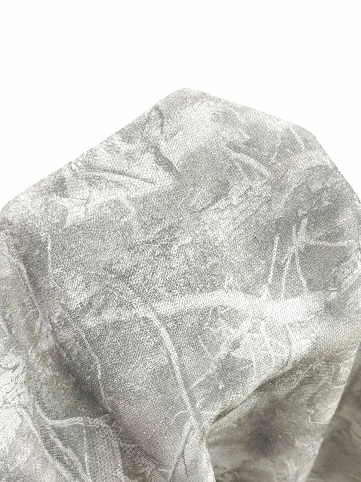 Close-up of the grey and white crackled branch print fabric on the hoodie