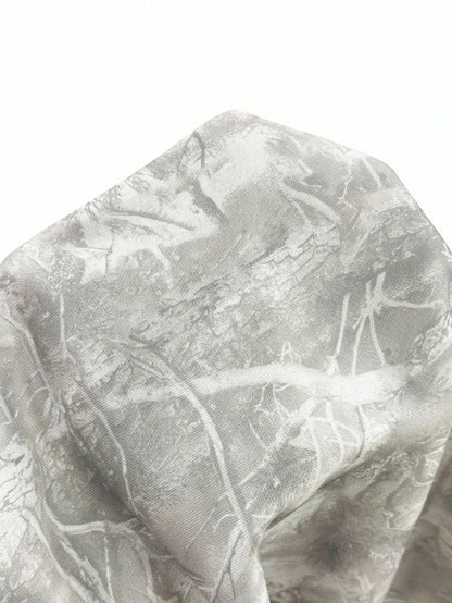 Close-up of the grey and white crackled branch print fabric on the hoodie