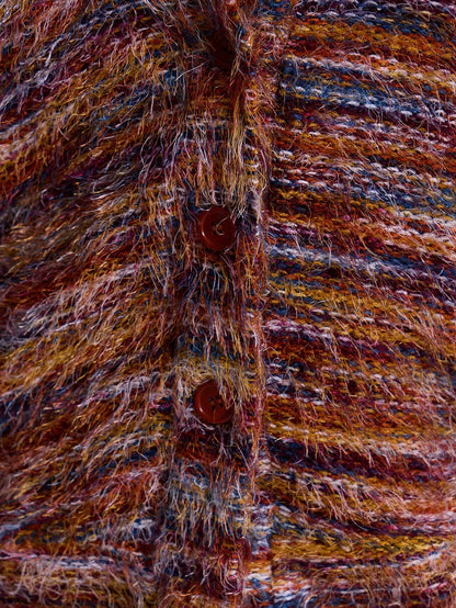 Close-up of the multicolor striped fuzzy knit fabric and button placket