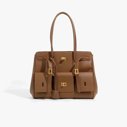 Brown leather-look tote bag with two front pockets and gold clasps, front view on a white background