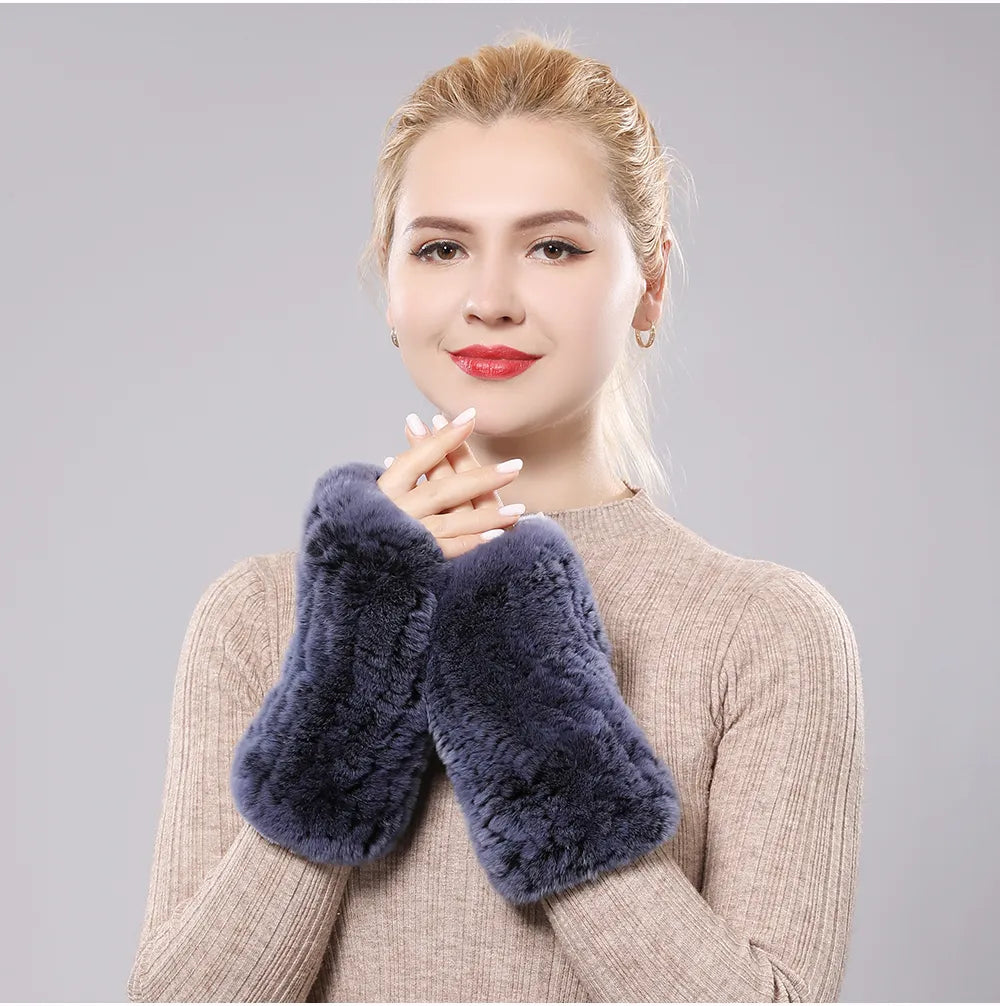 Woman wearing slate blue plush fingerless gloves with her hands together