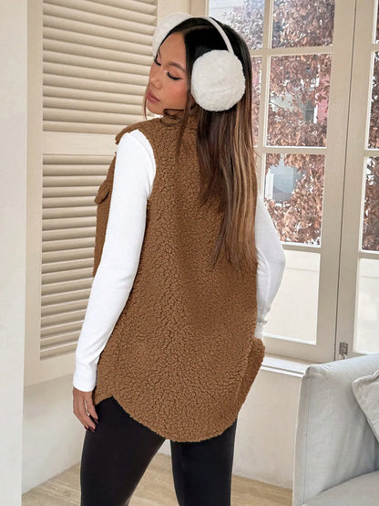 Back view of the brown teddy fleece vest with a curved hem, worn with white earmuffs
