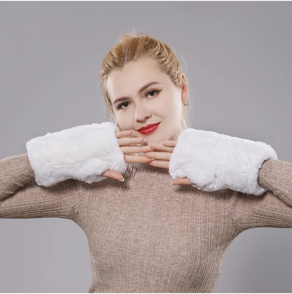 Woman wearing white plush fingerless gloves with her hands under her chin