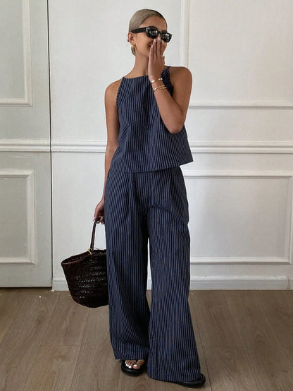 Woman wearing a navy pinstripe sleeveless top and matching wide-leg pants