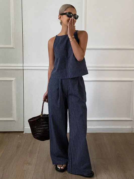 Woman wearing a navy pinstripe sleeveless top and matching wide-leg pants