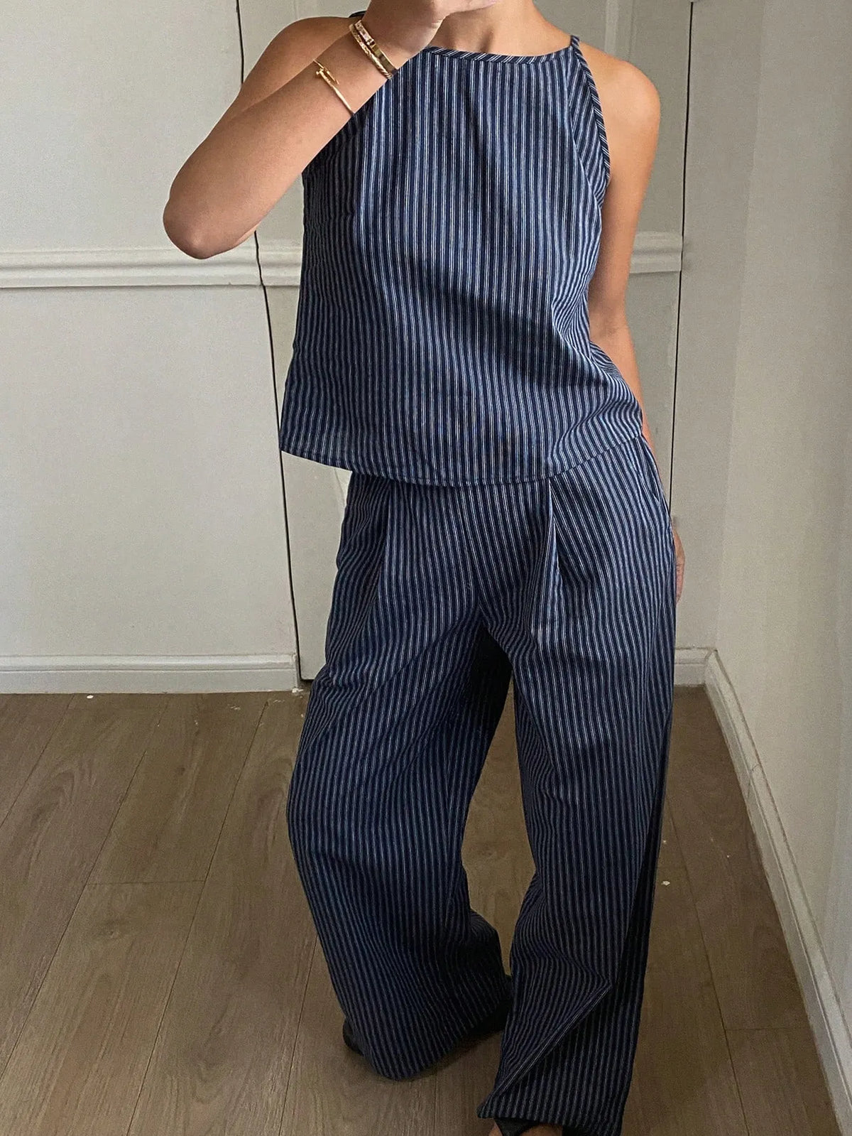 Navy pinstripe halter-neck top and pleated wide-leg pants set, front view