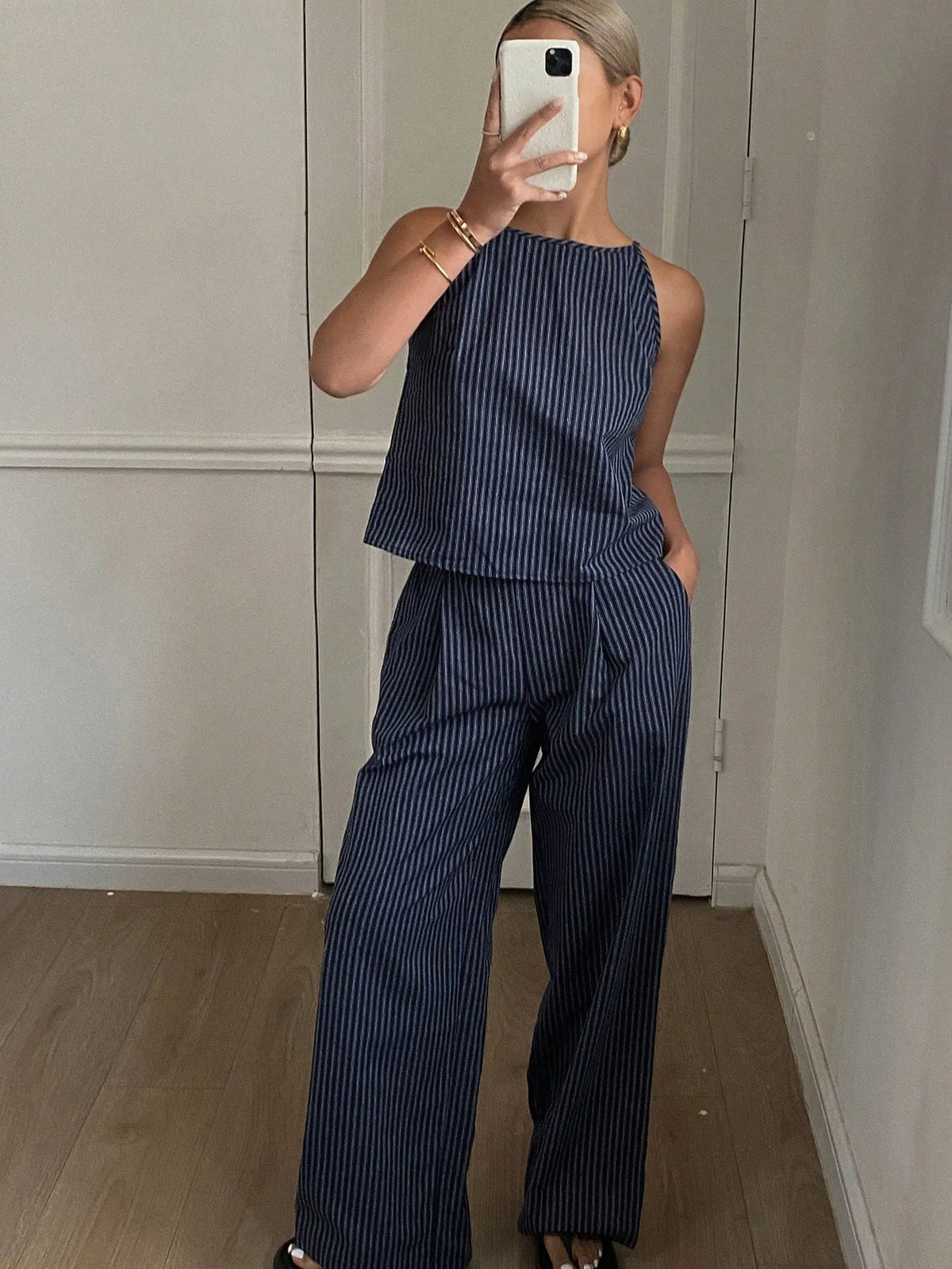 Navy pinstripe halter-neck top and wide-leg pants set worn for a mirror selfie, front view