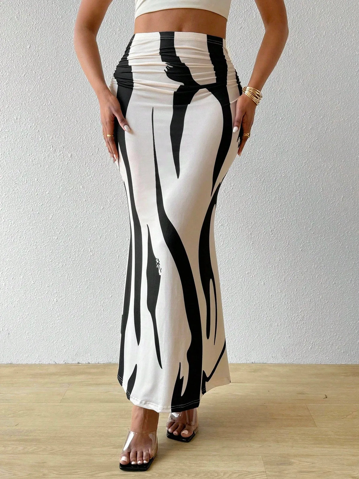 Black and white swirl print maxi skirt with a fitted waist and a flared hem, front view