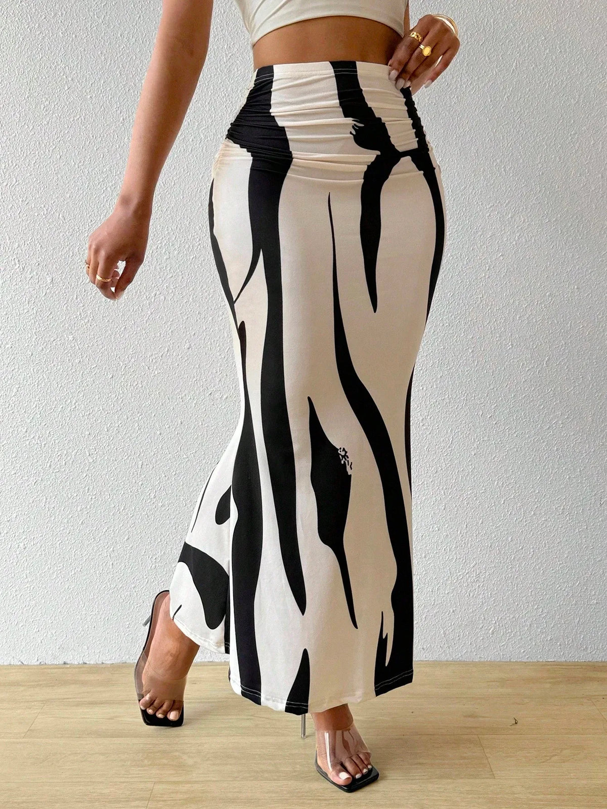 Black and white swirl print maxi skirt in a walking pose, three-quarter view