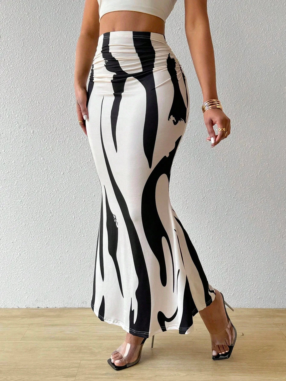 Front view of the black and white swirl print maxi skirt with strappy sandals