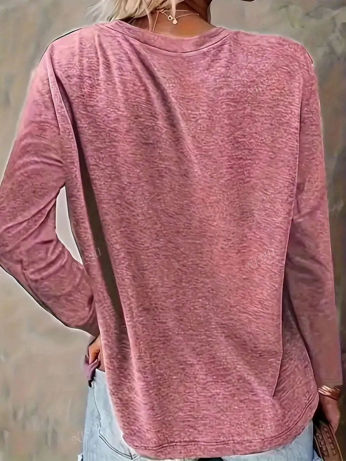 Back view of the coral pink long-sleeve tee with a curved hem