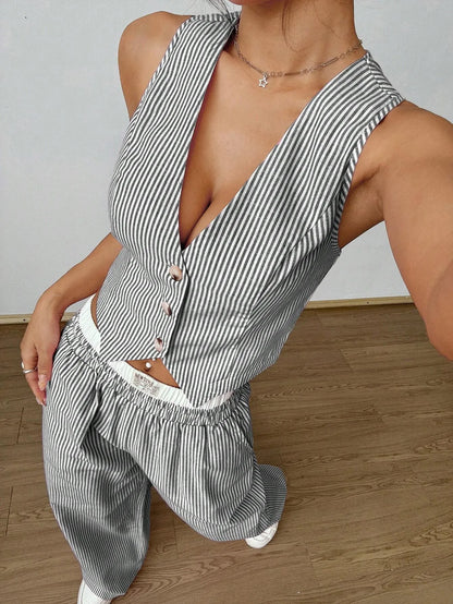 Grey pinstripe V-neck button-front vest top, close view in a leaning pose
