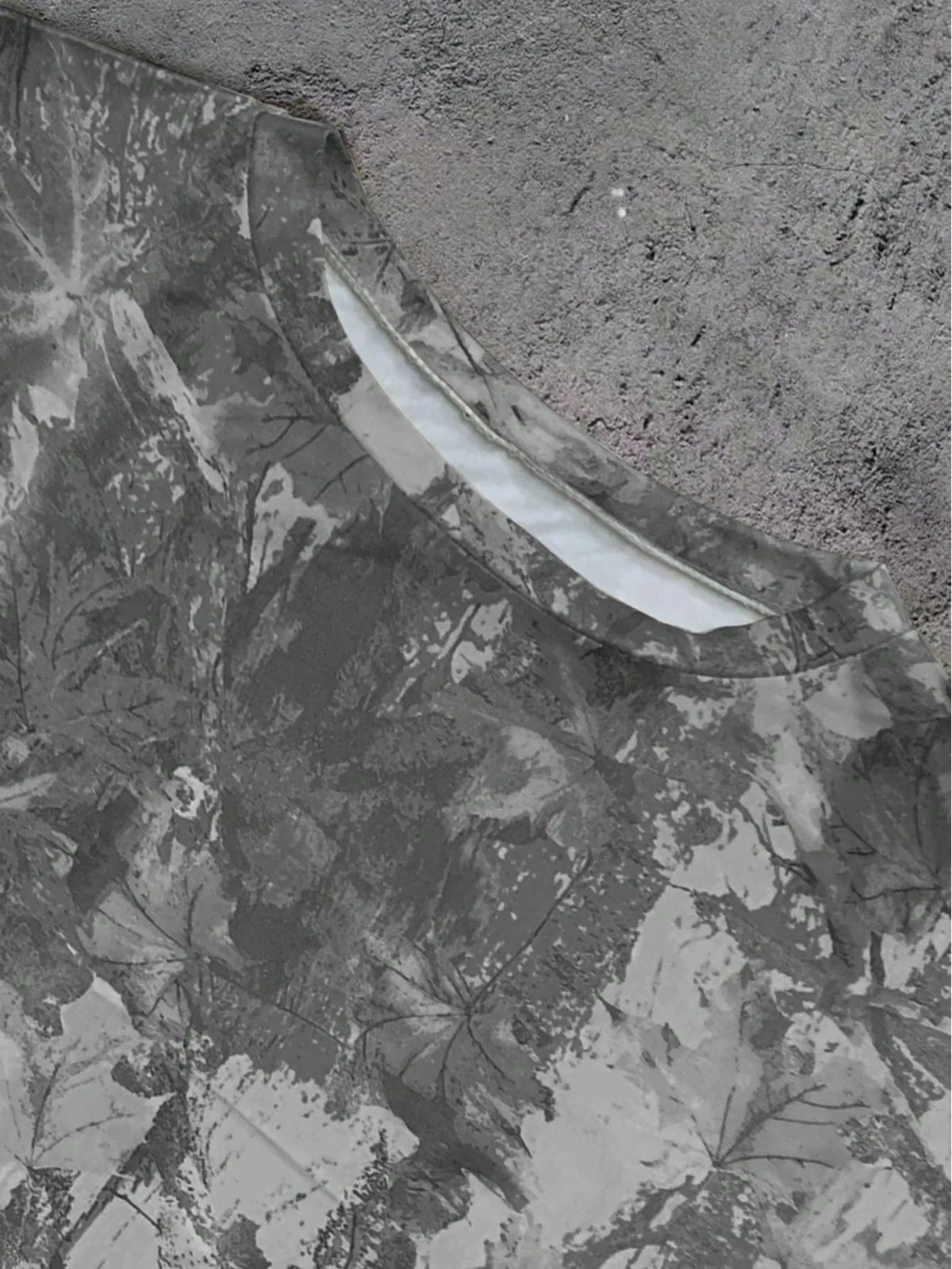Close-up of the grey camo print T-shirt collar and neckline