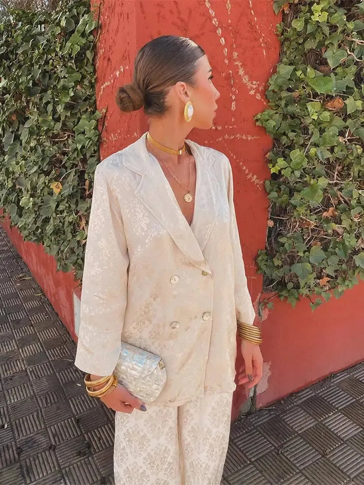 Side view of the cream patterned double-breasted blazer set with a small clutch