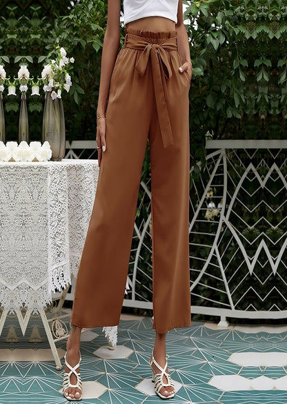 Woman wearing brown high-waisted wide-leg pants with a tie belt