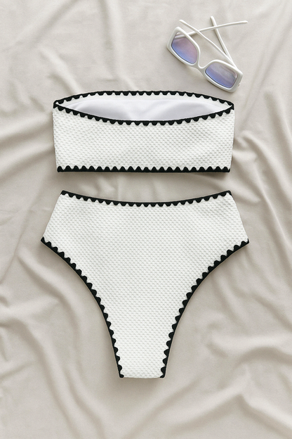 White textured bandeau top and high-waist bikini bottom with black trim, with sunglasses